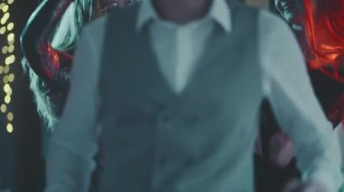 Partide dans eden beyaz, genç ve evli bir çiftin portresini yakın plan çek. Mutlu ve gülümseyen adamlar festival akşamında birlikte eğleniyorlar. Aile yeni yılı ya da Noel arifesini kutluyor..