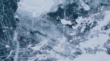 Donmuş Baykal Gölü, hava manzaralı. Pürüzsüz buzla güzel bir kış manzarası. Rusya 'nın ünlü doğal simgesi. Derin çatlakları olan mavi şeffaf buz, donmuş bir göl manzarası..