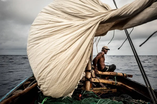 Night fishing. A man pulls out a fishing net at night. Indian Ocean. High quality photo