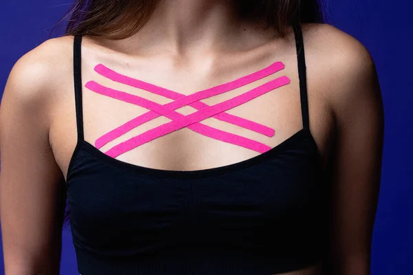 Cosmetology kinesio tapes on young woman chest. Body care modern treatment for tighten skin muscle tissue and improve blood circulation. Sport. Beautiful body. Fit. Care. High quality photo