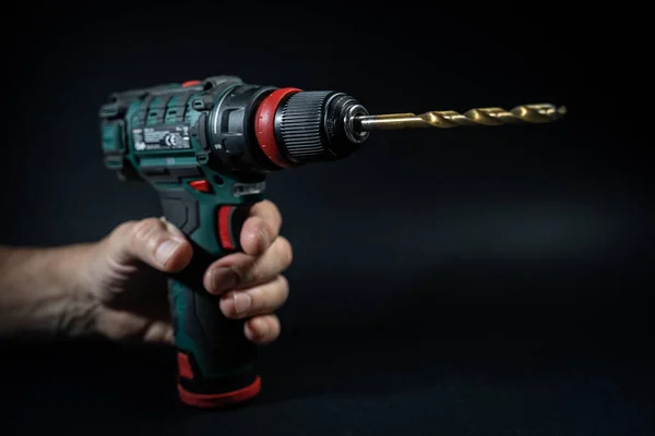 Close up hand drill concept. black background. craftsmanship