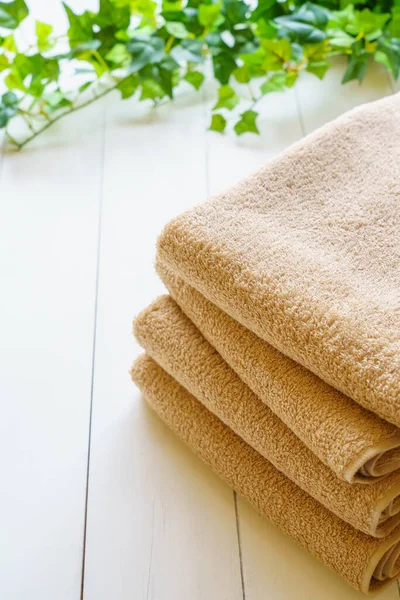 Stack of clean towels on wooden table