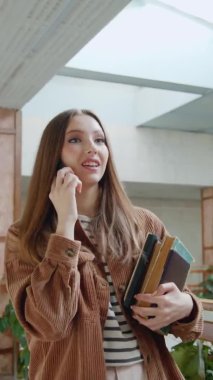 Kadın Lisans öğrencisi cep telefonuyla konuşuyor