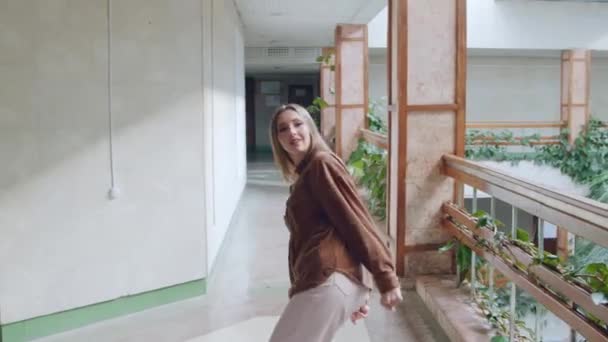 Jonge vrouw kijkt naar camera en dansen — Stockvideo