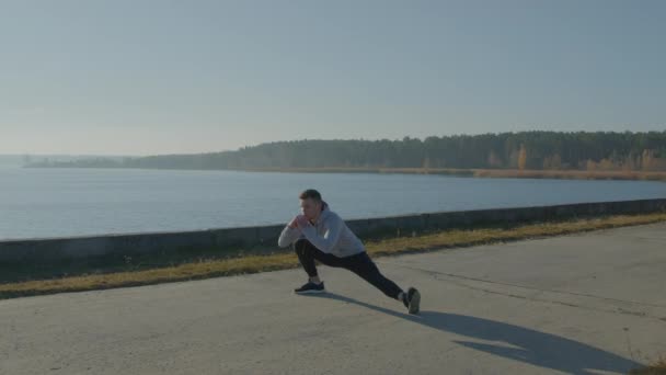 Young Man Is Doing Stretching Exercise On Lower Body — Stock Video