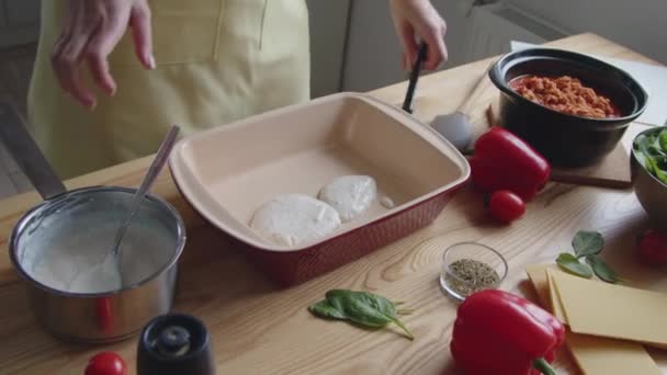 Cook βάζει λευκή σάλτσα σε Ovenware — Αρχείο Βίντεο