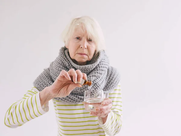 Senior Ill Woman Scarf Freezing Cold Put Drops Glass Water — Stock Photo, Image