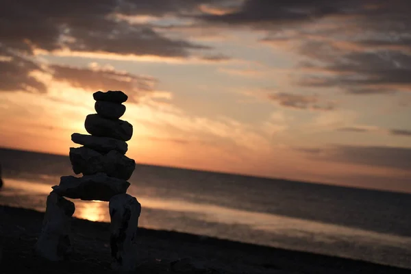 concept of balance and harmony. rocks on the coast of the Sea, Balanced stones on a pebble beach during sunset, landscape with sea shore, rocks in water and sand, Baltic Sea, rocks on the coast