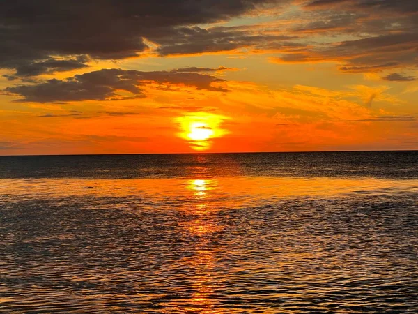 Closeup sea sand beach. Colorful golden sunset sky calmness tranquil relaxing sunlight summer vibes, Calm sea. A sunset at a beach. Meditation ocean and sky background. Horizon over the water.