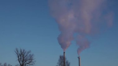 Winter city chimney with heavy smoke. Industrial factory pollution, smokestack exhaust gases. Industry zone, thick smoke. Climate change, ecology, atmosphere has, ozone layer