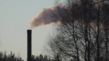 Winter city chimney with heavy smoke. Industrial factory pollution, smokestack exhaust gases. Industry zone, thick smoke. Climate change, ecology, atmosphere has, ozone layer