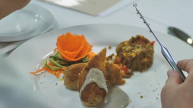 Yemek tatma bölümü teftişi. Ellerinle, çatalınla ve kaşığınla yenilen bir tabakta ye. Yumuşak seçici odak.