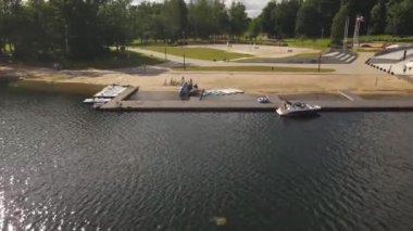 Aluksne lake shore with boat dock and playground