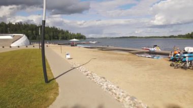 Aluksne lake shore with boat dock and playground