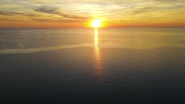 Sun setting reflection on seascape. Tropical golden sunset over ocean water aerial view. Calm waterscape at sunny evening.