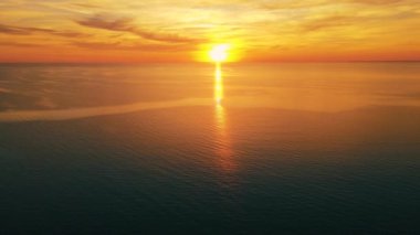 Sun setting reflection on seascape. Tropical golden sunset over ocean water aerial view. Calm waterscape at sunny evening.