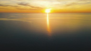 Sun setting reflection on seascape. Tropical golden sunset over ocean water aerial view. Calm waterscape at sunny evening.