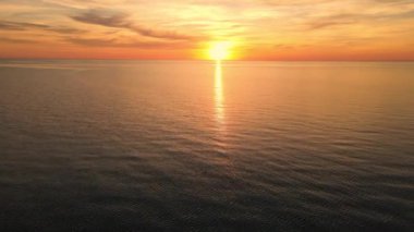 Sun setting reflection on seascape. Tropical golden sunset over ocean water aerial view. Calm waterscape at sunny evening.