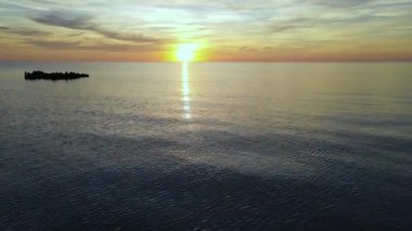 Sun setting reflection on seascape. Tropical golden sunset over ocean water aerial view. Calm waterscape at sunny evening.