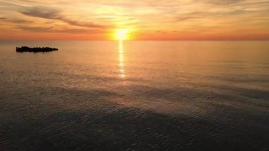 Sun setting reflection on seascape. Tropical golden sunset over ocean water aerial view. Calm waterscape at sunny evening.