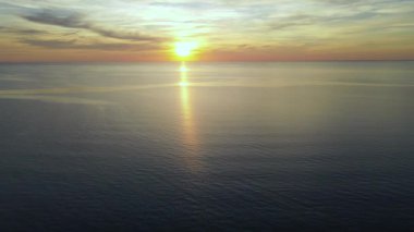 Sun setting reflection on seascape. Tropical golden sunset over ocean water aerial view. Calm waterscape at sunny evening.