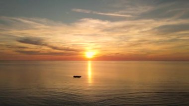 Sun setting reflection on seascape. Tropical golden sunset over ocean water aerial view. Calm waterscape at sunny evening.