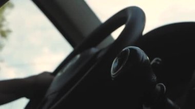 Using Windshield Wiper Car Wheel. Woman Driver Hand On Car Steering Wheels. Transport Driver Turning Steering Wheel Car. Business woman driving a car.