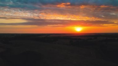 Sunset from above flying towards the sun. A shot of a drone flying in twilight at sunset