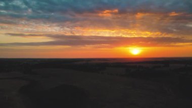 Sunset from above flying towards the sun. A shot of a drone flying in twilight at sunset