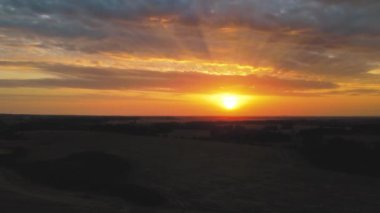 Sunset from above flying towards the sun. A shot of a drone flying in twilight at sunset