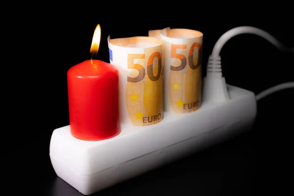 Energy price increase. Burning candles with a euro banknote. Increase in energy bill prices.