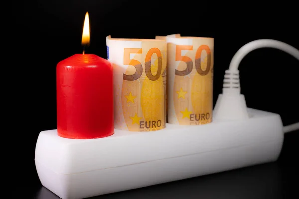 Energy price increase. Burning candles with a euro banknote. Increase in energy bill prices.