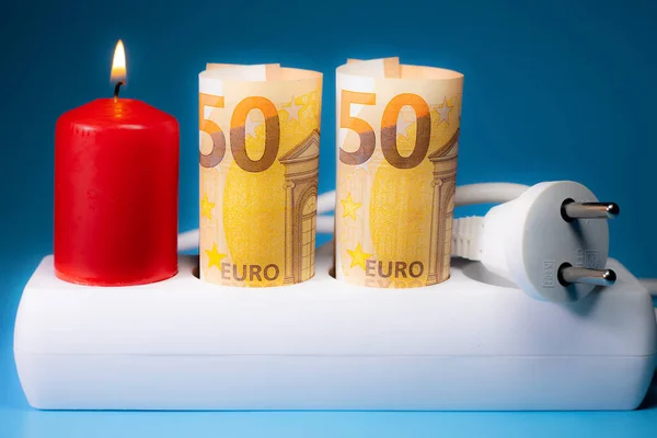 Energy price increase. Burning candles with a euro banknote. Increase in energy bill prices.