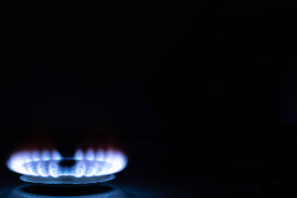 Gas burns with blue flames. Gas crisis around the world. Selective focus on the flame. Soft focus on the picture. Natural gas for housing