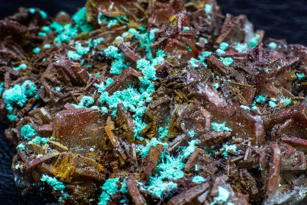 Real brown albite crystal cluster with small light green malachite clusters isolated on black. Macro