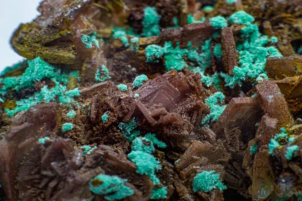 Real brown albite crystal cluster with small light green malachite clusters isolated on white. Macro