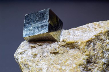 Gri arkaplan yüzeyinde izole edilmiş beyaz matris makrosu üzerindeki makro gri mükemmel kübik pirit metali  