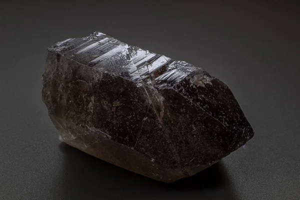 Macro gray brown smoky quartz natural point macro isolated on a black surface background