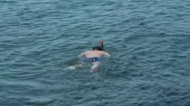 Aktif ve sağlıklı bir adam yaz güneşli bir günde dalış sırasında dalgıçlık yapıyor.