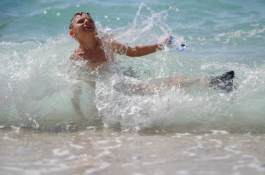 kid with diving mask and flippers falling in sea water splash during summer outdoors leisure activity holiday