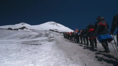 many sport people with climbing equipment rising on high mountain during outdoor leisure activity peak of snow highland with copy space