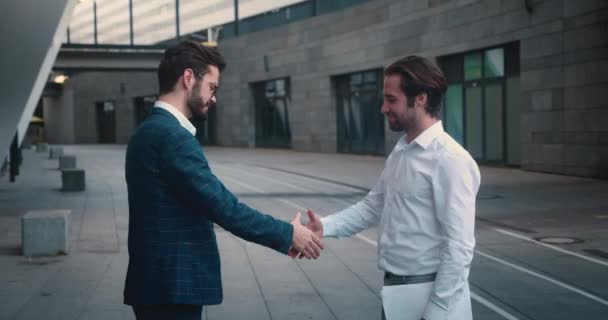 Pessoas de negócios que se encontram na rua apertando as mãos felizes e sorrindo. Dois aperto de mão confiante homem de negócios. — Vídeo de Stock
