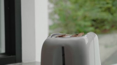 bej tost makinesi ve iki parça ekmek. Mutfakta tost makinesi Tost yapıyor