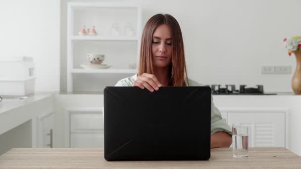 Happy aucasians woman opens up laptop ready to get online — Videoclip de stoc
