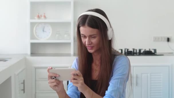 Female Headphone Relaxing Playing Game Her Smartphone Smiling — Stockvideo