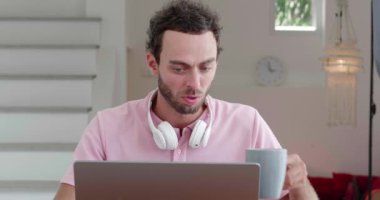 European successful male entrepreneur drinking hot coffee while working on new project on laptop. Business. Start-up.