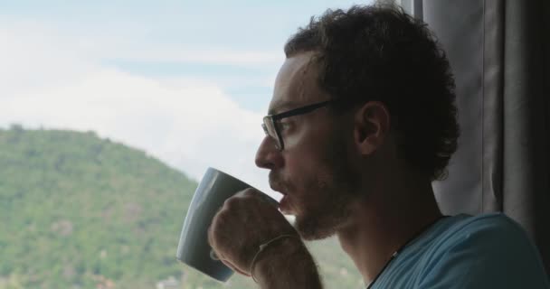 Relaxed Man Stands Window Admiring Beautiful Tropical Landscape While Having — Video