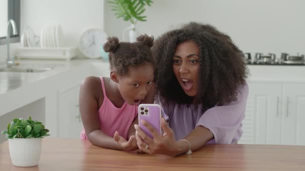 Многонациональная Молодая Женщина Маленькой Дочерью Смотрящей Камеру Используя Мобильный Телефон — стоковое видео