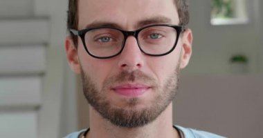 Caucasian bearded man in glasses for vision, takes them off when suddenly shocked, looks at the camera with stupefaction