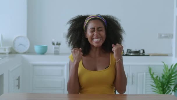 Positive Woman Dressed Bright Yellow Looks Camera Rejoicing Clenching Fists — Vídeo de Stock